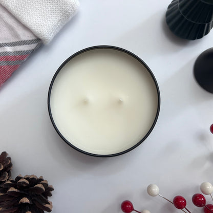 Top view of Fragrance & Fire candle unlit surrounded by christmas decor.